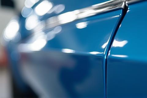 Reflection on a highly polished car door demonstrating paint shine